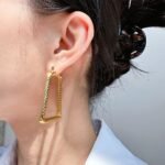 Wholesale geometry Hoop Earrings featuring gear motifs, snake-pattern facets, and geometric trapezoid hoops plated in 18K gold-over-copper from junejewelry.com—factory price, free shipping.