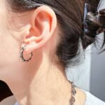 Wholesale Industrial Gear Hoop Earrings featuring rotating gear motifs on copper hoops plated in 18K gold or platinum from junejewelry.com—factory price, free shipping.