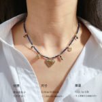 Wholesale lapis lazuli layering necklace featuring lapis beads, a gold coin pendant, shell accents, and 18K gold plated copper from junejewelry.com