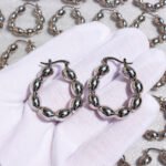 Wholesale Olive Bead U-Shape Hoop Earrings featuring olive seed beads on a copper band plated in 18K gold and platinum from junejewelry.com—factory price, free shipping.