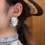 Wholesale Sun Relief Stud Earrings featuring vintage relief sun medallion and twisted ribbon knot on copper with 18K gold or platinum plating from junejewelry.com—factory price, free shipping.