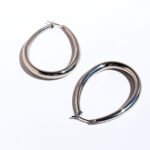 Wholesale Oval Teardrop U-Shape Clip Earrings featuring oversized teardrop and geometric hollow U-shape clip in 18K gold-plated copper from junejewelry.com—factory price, free shipping.