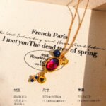 Wholesale lapis lazuli layering necklace featuring lapis beads, a gold coin pendant, shell accents, and 18K gold plated copper from junejewelry.com