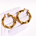 Wholesale geometry Hoop Earrings featuring gear motifs, snake-pattern facets, and geometric trapezoid hoops plated in 18K gold-over-copper from junejewelry.com—factory price, free shipping.