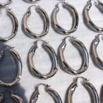 Wholesale Wave Chain Hoop Earrings featuring oversized wave motif and hollow chain buckle on 18K gold- or platinum-plated copper hoops from junejewelry.com—factory price, free shipping.