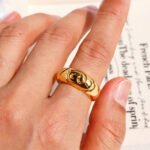 Wholesale Vintage Relief Ring featuring handcrafted relief linework and old-coin motif in 18K gold–plated copper from junejewelry.com—factory price, free shipping.