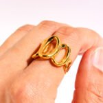 Wholesale Hollow Oval Wide Band Ring with hollow oval shape and bold lines in 18K gold-plated copper from junejewelry.com—factory price, free shipping.