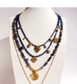 Wholesale lapis lazuli layering necklace featuring lapis beads, a gold coin pendant, shell accents, and 18K gold plated copper from junejewelry.com