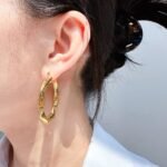 Wholesale geometry Hoop Earrings featuring gear motifs, snake-pattern facets, and geometric trapezoid hoops plated in 18K gold-over-copper from junejewelry.com—factory price, free shipping.