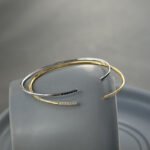 Wholesale cubic zirconia cuff bracelet featuring a minimalist design and 14K gold plated copper from junejewelry.com