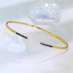 Wholesale cubic zirconia cuff bracelet featuring a minimalist design and 14K gold plated copper from junejewelry.com