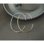 Wholesale cubic zirconia cuff bracelet featuring a minimalist design and 14K gold plated copper from junejewelry.com