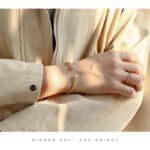 Wholesale dual CZ cuff bracelet featuring a minimalist design and 14K gold plated copper from junejewelry.com