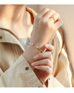 Wholesale dual CZ cuff bracelet featuring a minimalist design and 14K gold plated copper from junejewelry.com