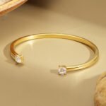 Wholesale dual CZ cuff bracelet featuring a minimalist design and 14K gold plated copper from junejewelry.com