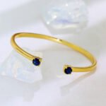 Wholesale dual CZ cuff bracelet featuring a minimalist design and 14K gold plated copper from junejewelry.com