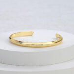 Wholesale C shape cuff bracelet featuring a minimalist design and 14K gold plated copper from junejewelry.com