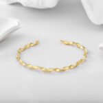 Wholesale twisted cuff bracelet featuring a minimalist design and 14K gold plated copper from junejewelry.com