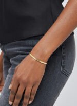 Wholesale single CZ cuff bracelet featuring a minimalist design and 14K gold plated copper from junejewelry.com