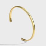Wholesale single CZ cuff bracelet featuring a minimalist design and 14K gold plated copper from junejewelry.com