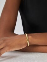 Wholesale single CZ cuff bracelet featuring a minimalist design and 14K gold plated copper from junejewelry.com