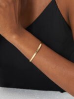 Wholesale single CZ cuff bracelet featuring a minimalist design and 14K gold plated copper from junejewelry.com