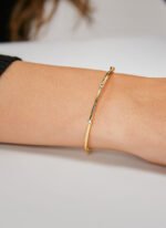 Wholesale CZ cuff bracelet featuring a minimalist design and 14K gold plated copper from junejewelry.com