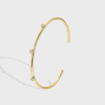 Wholesale CZ cuff bracelet featuring a minimalist design and 14K gold plated copper from junejewelry.com