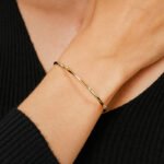 Wholesale CZ cuff bracelet featuring a minimalist design and 14K gold plated copper from junejewelry.com