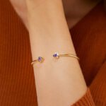 Wholesale geometric zirconia bracelet featuring a minimalist design with triangular CZ stones and 14K gold plated copper from junejewelry.com