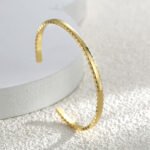 Wholesale geometric cuff bracelet featuring a minimalist geometric design and 14K gold plated copper from junejewelry.com