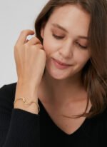 Wholesale wave cuff bracelet featuring a minimalist wavy design and 14K gold plated copper from junejewelry.com