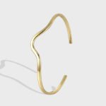 Wholesale wave cuff bracelet featuring a minimalist wavy design and 14K gold plated copper from junejewelry.com