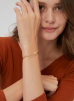 Wholesale lightning cuff bracelet featuring a minimalist lightning bolt design and 14K gold plated copper from junejewelry.com