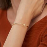 Wholesale lightning cuff bracelet featuring a minimalist lightning bolt design and 14K gold plated copper from junejewelry.com