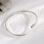 Wholesale European-style snake cuff bracelet featuring an asymmetrical snake design and 14K gold plated copper from junejewelry.com