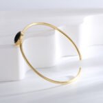 Wholesale European-style black agate cuff bracelet featuring a minimalist design and 14K gold plated copper from junejewelry.com