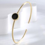 Wholesale European-style black agate cuff bracelet featuring a minimalist design and 14K gold plated copper from junejewelry.com