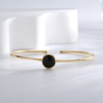 Wholesale European-style black agate cuff bracelet featuring a minimalist design and 14K gold plated copper from junejewelry.com