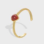 Wholesale European-style red agate cuff bracelet featuring a minimalist design and 14K gold plated copper from junejewelry.com