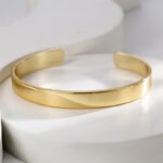 Wholesale European-style modern cuff bracelet featuring a minimalist design and 14K gold plated copper from junejewelry.com