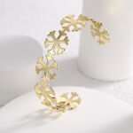Wholesale European-style minimalist snowflake cuff bracelet featuring a 14k gold plated copper design from junejewelry.com