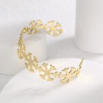 Wholesale European-style minimalist snowflake cuff bracelet featuring a 14k gold plated copper design from junejewelry.com