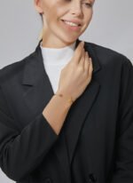 Wholesale European-style minimalist moon cuff bracelet featuring a 14k gold plated copper design with a purple stone from junejewelry.com