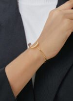 Wholesale European-style minimalist moon cuff bracelet featuring a 14k gold plated copper design with a purple stone from junejewelry.com