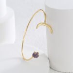 Wholesale European-style minimalist moon cuff bracelet featuring a 14k gold plated copper design with a purple stone from junejewelry.com