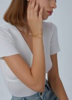 Wholesale European-style minimalist snake cuff bracelet featuring a 14k gold plated copper design with CZ stone detailing from junejewelry.com