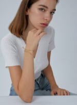 Wholesale European-style minimalist snake cuff bracelet featuring a 14k gold plated copper design with CZ stone detailing from junejewelry.com