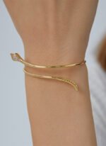 Wholesale European-style minimalist snake cuff bracelet featuring a 14k gold plated copper design with CZ stone detailing from junejewelry.com