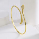 Wholesale European-style minimalist snake cuff bracelet featuring a 14k gold plated copper design with CZ stone detailing from junejewelry.com